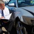 Loss Adjuster Inspecting Car Involved In Accident